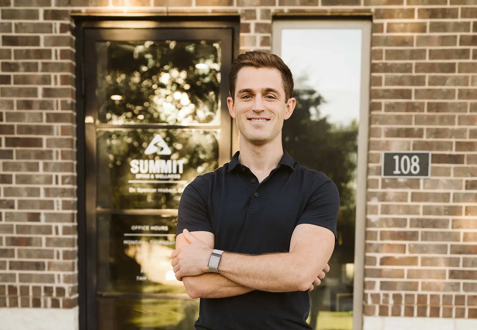 Dr. Spencer Hiebert standing outside the Summit Spine & Wellness entrance