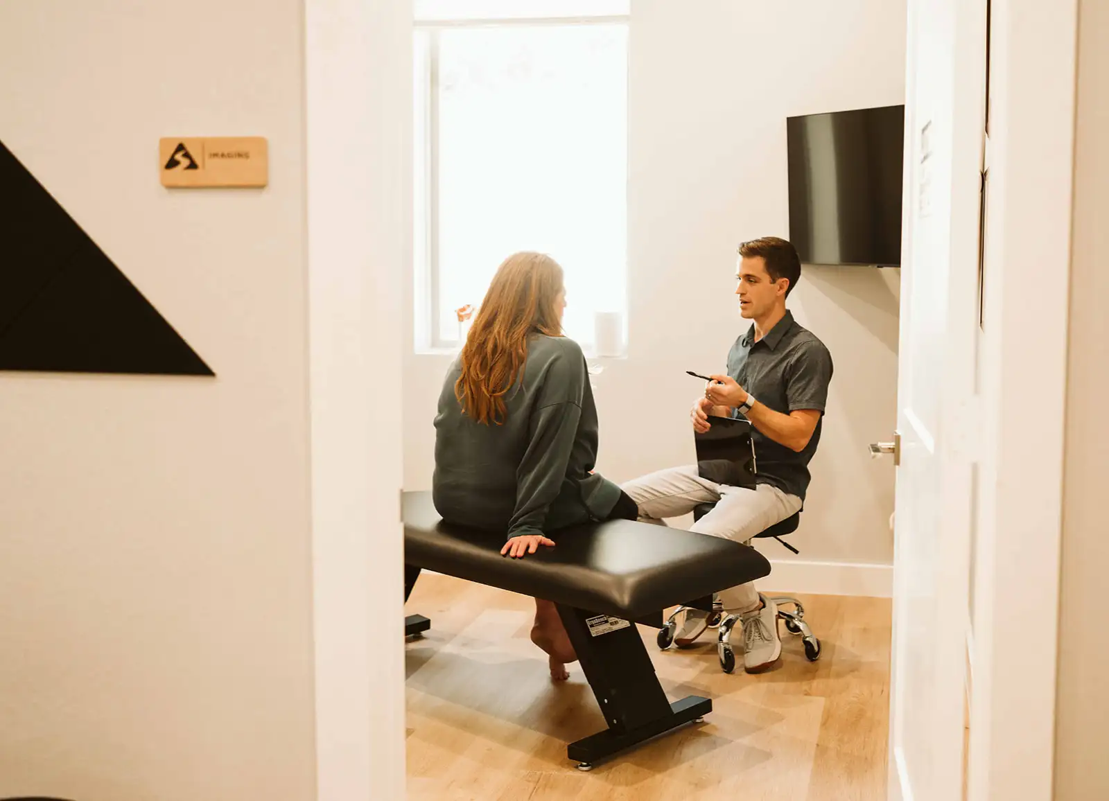 Dr. Hiebert talking with a patient in an examination room