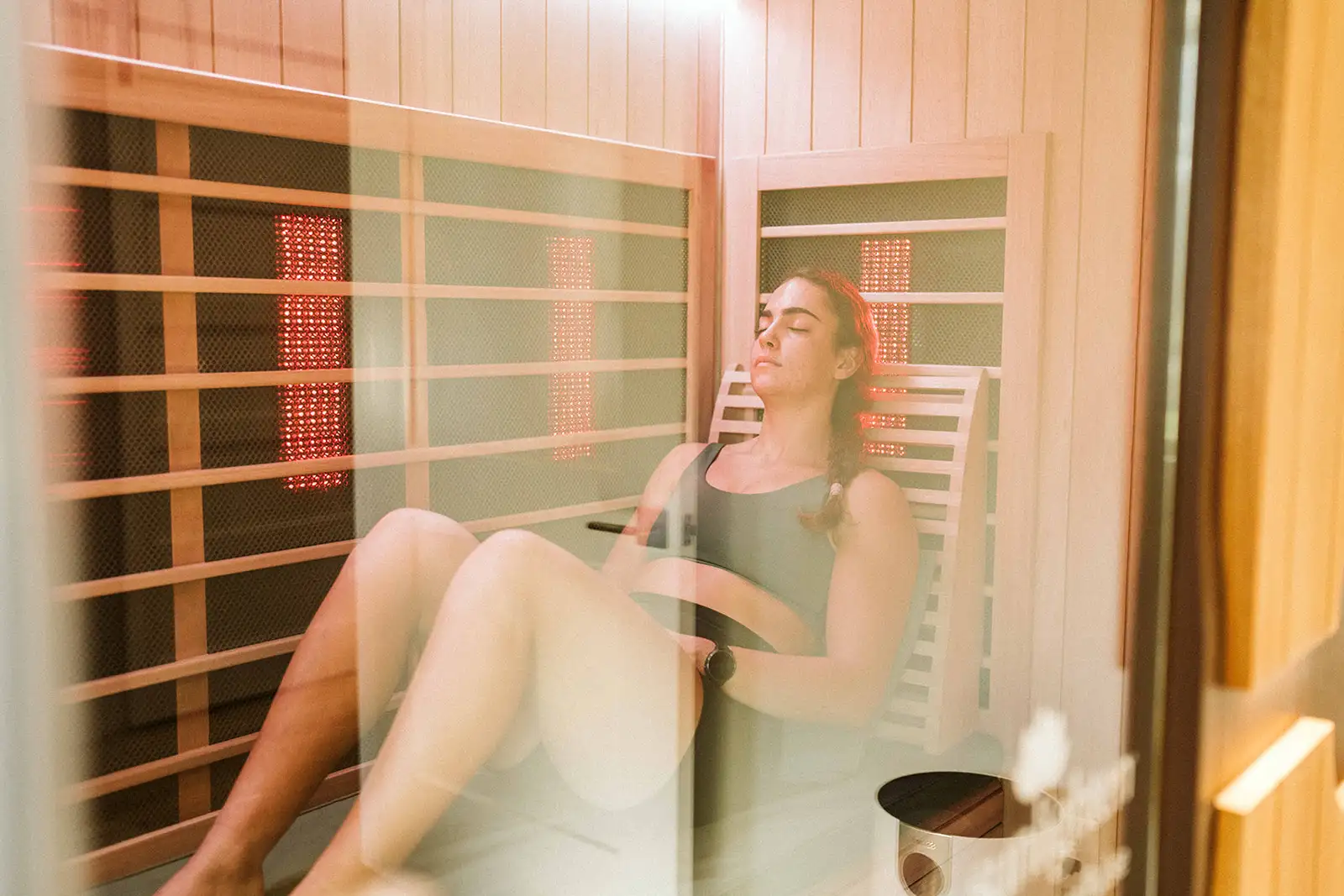 Woman reclining inside the infrared sauna